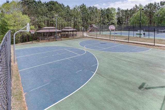 view of sport court with community basketball court, a gazebo, and fence