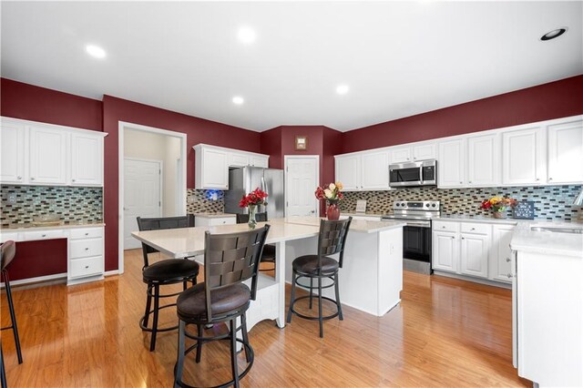 5312 Tormeal Trce, Suwanee, GA 30024 - kitchen featuring stainless steel appliances, decorative backsplash, a kitchen island, and recessed lighting