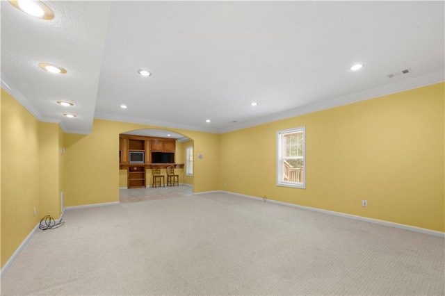 5312 Tormeal Trce, Suwanee, GA 30024 - unfurnished living room featuring arched walkways, light carpet, baseboards, recessed lighting, and crown molding