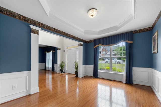 5312 Tormeal Trce, Suwanee, GA 30024 - spare room with ornamental molding, a wainscoted wall, a raised ceiling, wood finished floors, and a decorative wall