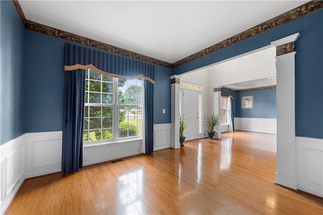5312 Tormeal Trce, Suwanee, GA 30024 - spare room featuring wainscoting, healthy amount of natural light, a decorative wall, and wood finished floors