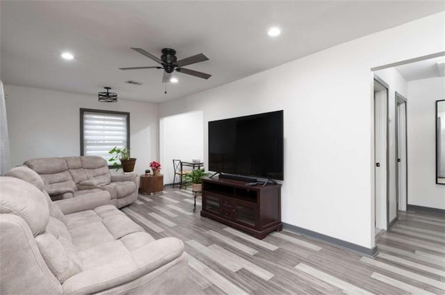 living room featuring ceiling fan and light wood-type flooring