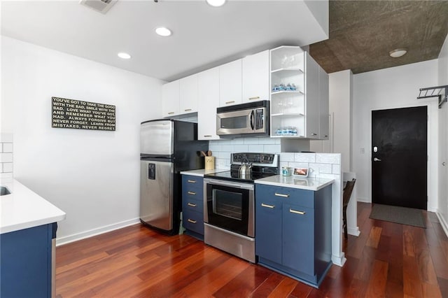 kitchen featuring stainless steel appliances, white cabinetry, tasteful backsplash, and dark hardwood / wood-style flooring