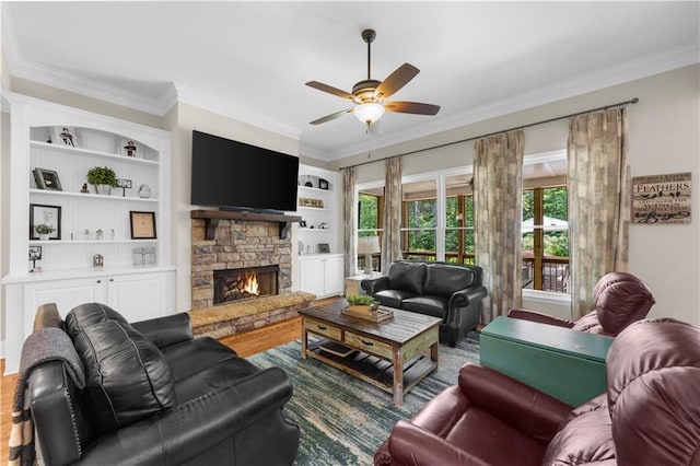 989 Pink Williams Rd, Dahlonega, GA 30533 - living area with ornamental molding, wood finished floors, ceiling fan, a stone fireplace, and built in shelves