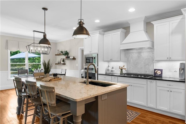 989 Pink Williams Rd, Dahlonega, GA 30533 - kitchen with appliances with stainless steel finishes, a center island with sink, a sink, premium range hood, and wood finished floors