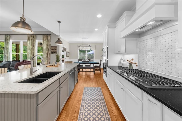 989 Pink Williams Rd, Dahlonega, GA 30533 - kitchen with stainless steel appliances, a sink, premium range hood, an island with sink, and light wood finished floors