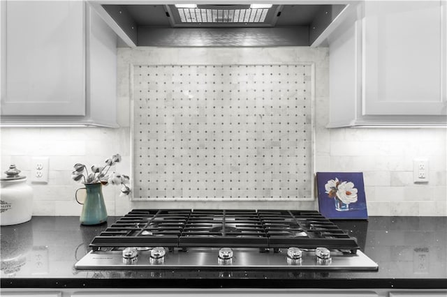 989 Pink Williams Rd, Dahlonega, GA 30533 - kitchen featuring exhaust hood, decorative backsplash, stainless steel gas cooktop, white cabinetry, and dark countertops