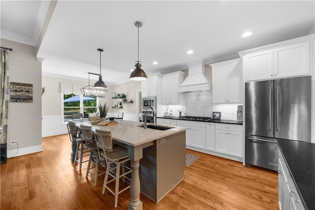 989 Pink Williams Rd, Dahlonega, GA 30533 - kitchen featuring stainless steel appliances, a sink, ornamental molding, premium range hood, and white cabinets