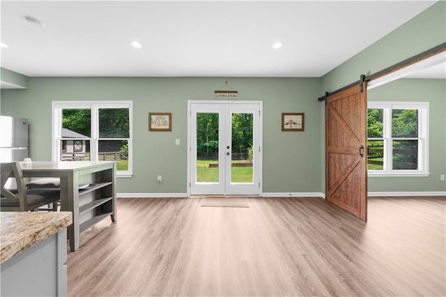 989 Pink Williams Rd, Dahlonega, GA 30533 - dining space with light wood-style flooring, baseboards, a barn door, recessed lighting, and french doors