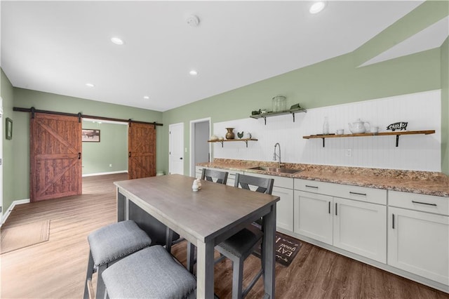 989 Pink Williams Rd, Dahlonega, GA 30533 - kitchen with open shelves, a sink, a barn door, wood finished floors, and recessed lighting