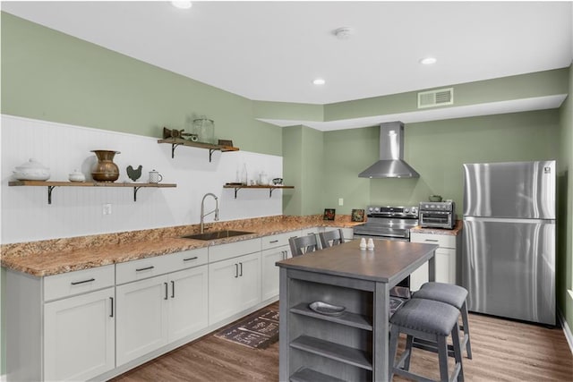 989 Pink Williams Rd, Dahlonega, GA 30533 - kitchen with open shelves, stainless steel appliances, wall chimney exhaust hood, a sink, and light wood-style flooring