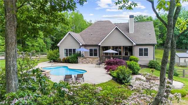 989 Pink Williams Rd, Dahlonega, GA 30533 - back of house with a patio area, a chimney, an outdoor pool, and roof with shingles