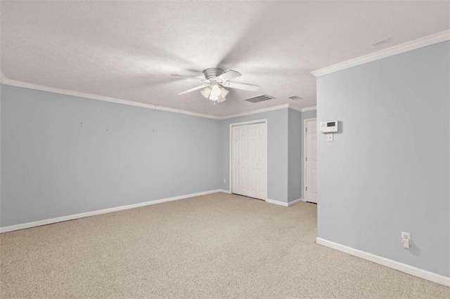 spare room with light carpet, ceiling fan, and crown molding