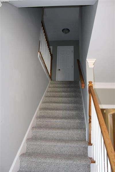 2031 Lakewood Cir, Grayson, GA 30017 - stairs with carpet and baseboards