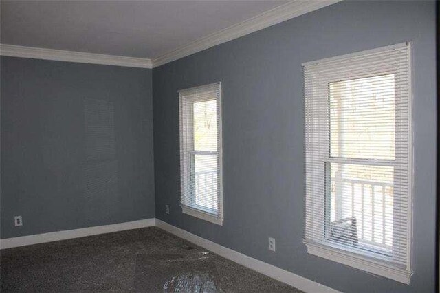 2031 Lakewood Cir, Grayson, GA 30017 - spare room featuring ornamental molding, baseboards, and dark colored carpet
