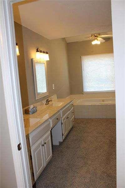 2031 Lakewood Cir, Grayson, GA 30017 - full bathroom with double vanity and a tub
