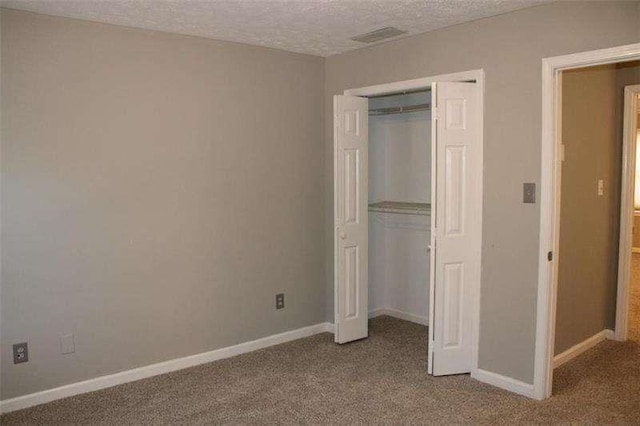 2031 Lakewood Cir, Grayson, GA 30017 - unfurnished bedroom with carpet flooring, a closet, baseboards, and a textured ceiling