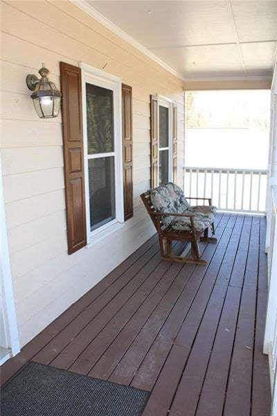 2031 Lakewood Cir, Grayson, GA 30017 - wooden deck with covered porch