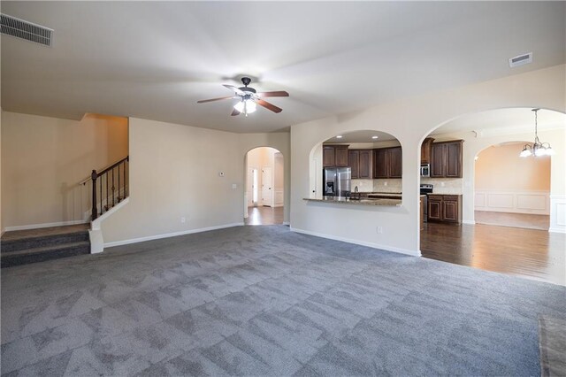 hallway featuring crown molding, decorative columns, and a raised ceiling