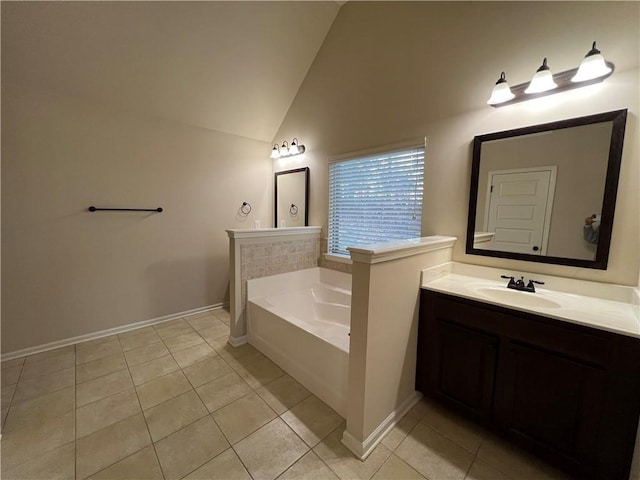 bathroom with a washtub, tile patterned flooring, lofted ceiling, and vanity