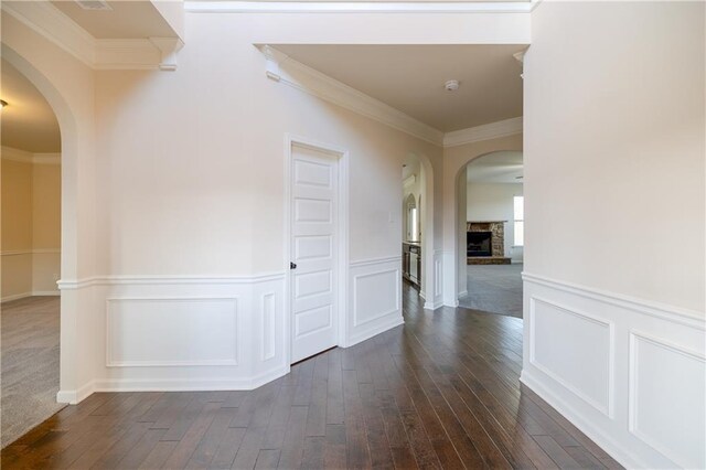 hallway featuring dark wood-type flooring and crown molding