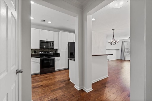 400 17th St NW Unit 1321, Atlanta, GA 30363 - kitchen featuring electric range oven, stainless steel microwave, dark countertops, dark wood-style floors, and ornamental molding