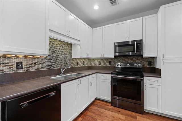 400 17th St NW Unit 1321, Atlanta, GA 30363 - kitchen featuring stainless steel microwave, range with electric stovetop, dishwasher, a sink, and dark countertops