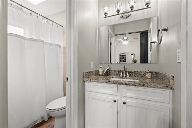 bathroom with vanity, ceiling fan, and toilet