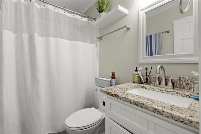 bathroom with vanity, toilet, and crown molding