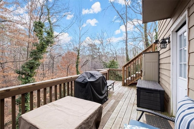 wooden terrace with a grill