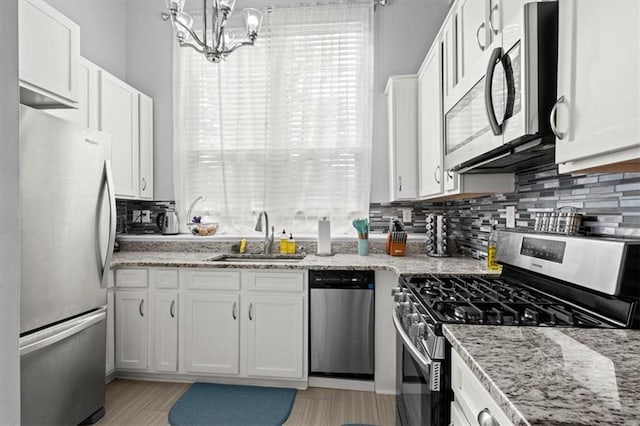 kitchen with white cabinets, sink, and appliances with stainless steel finishes