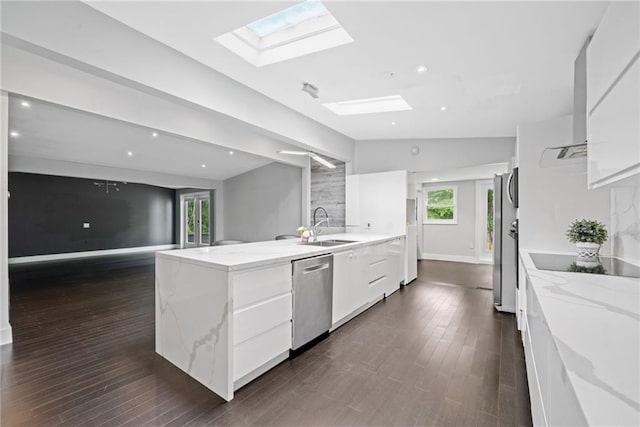 2123 Drew Valley Rd NE, Brookhaven, GA 30319 - kitchen featuring appliances with stainless steel finishes, a skylight, modern cabinets, a sink, and vaulted ceiling