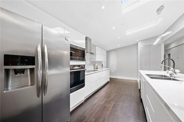 2123 Drew Valley Rd NE, Brookhaven, GA 30319 - kitchen featuring appliances with stainless steel finishes, modern cabinets, a sink, wall chimney range hood, and white cabinetry