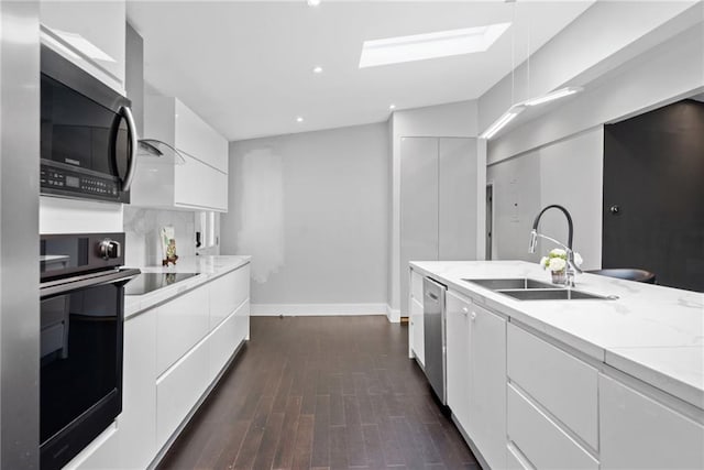 2123 Drew Valley Rd NE, Brookhaven, GA 30319 - kitchen featuring black appliances, a sink, modern cabinets, white cabinets, and baseboards