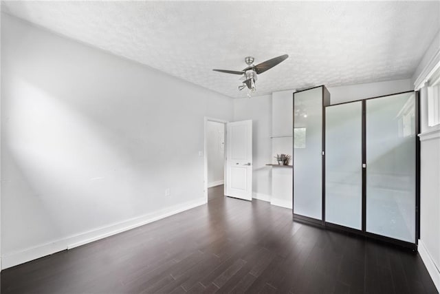 2123 Drew Valley Rd NE, Brookhaven, GA 30319 - empty room with a ceiling fan, a textured ceiling, dark wood finished floors, baseboards, and plenty of natural light
