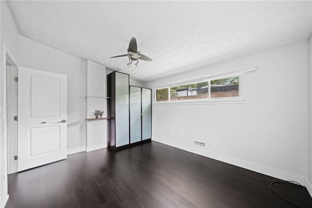 2123 Drew Valley Rd NE, Brookhaven, GA 30319 - unfurnished bedroom featuring baseboards, wood finished floors, a textured ceiling, and a ceiling fan