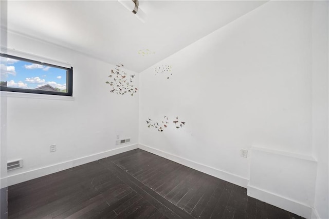 2123 Drew Valley Rd NE, Brookhaven, GA 30319 - empty room featuring dark wood finished floors, baseboards, and vaulted ceiling