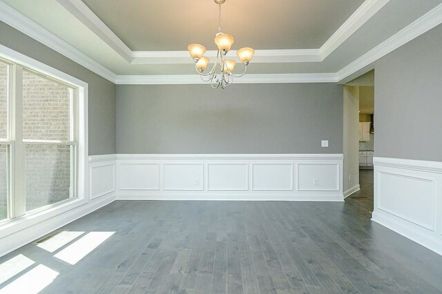 entrance foyer with a towering ceiling, dark hardwood / wood-style floors, an inviting chandelier, and french doors