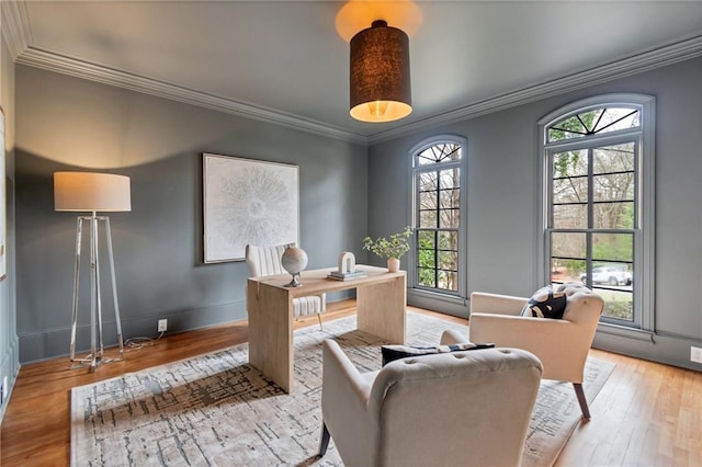 office area with light hardwood / wood-style flooring and ornamental molding