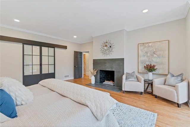 bedroom featuring hardwood / wood-style flooring and ornamental molding