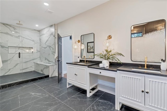 bathroom with a shower with door and vanity