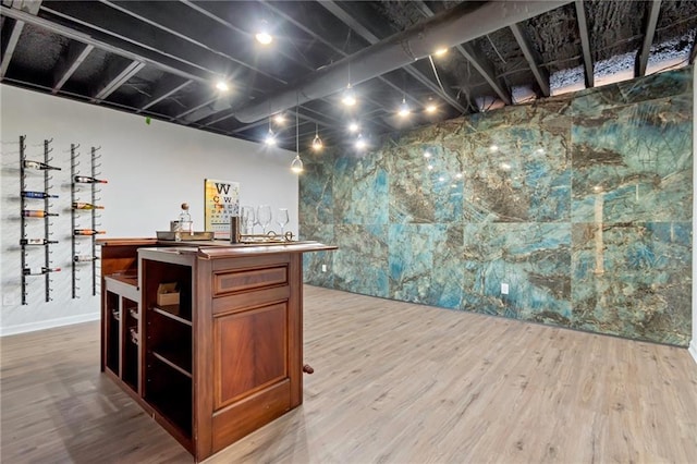 bar featuring light hardwood / wood-style floors