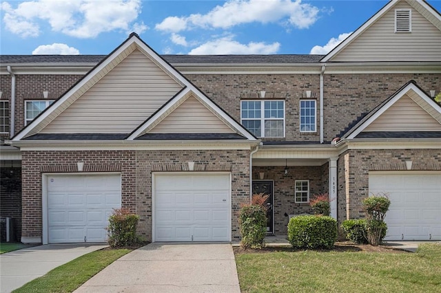 traditional home featuring brick siding, driveway, and a garage