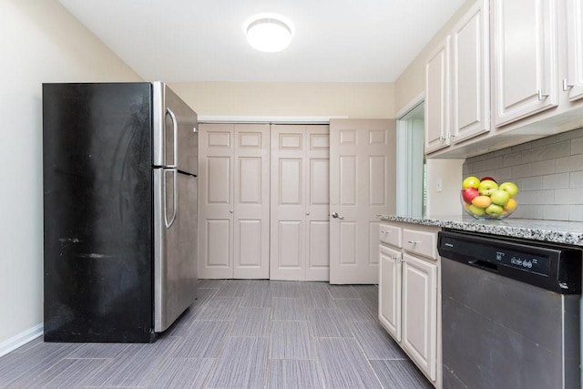 kitchen with white cabinets, decorative backsplash, appliances with stainless steel finishes, and light stone countertops