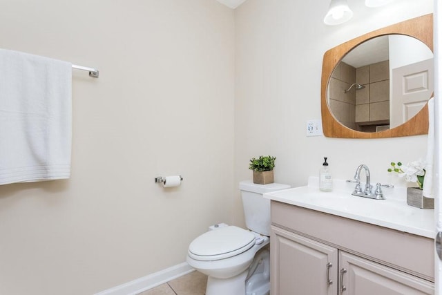 bathroom with toilet, vanity, and tile patterned floors