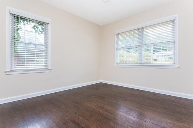 unfurnished room featuring hardwood / wood-style flooring