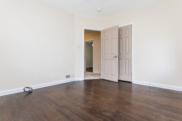 empty room with dark hardwood / wood-style floors