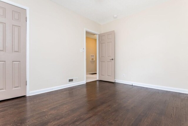 spare room featuring dark hardwood / wood-style flooring