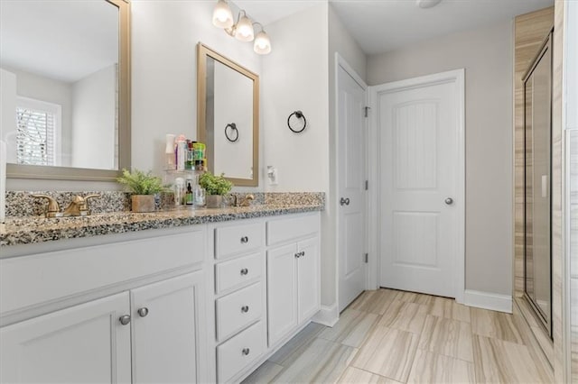 bathroom featuring vanity and a shower with shower door