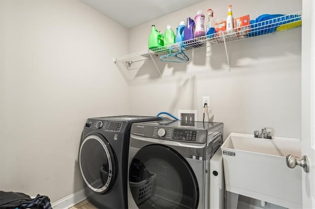 laundry area with sink and washer and dryer